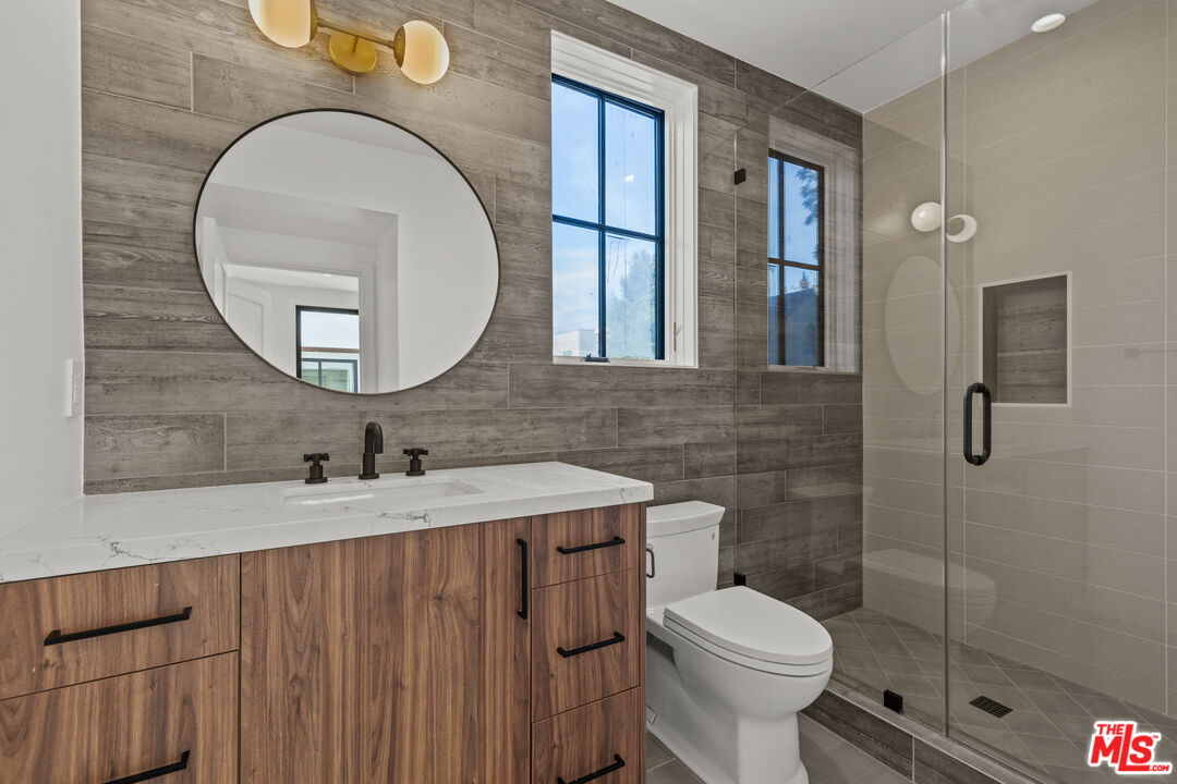 5538 Tova Road Sherman Oaks, CA 91411 - Photo 14 of 19 a bathroom with a toilet a sink and mirror