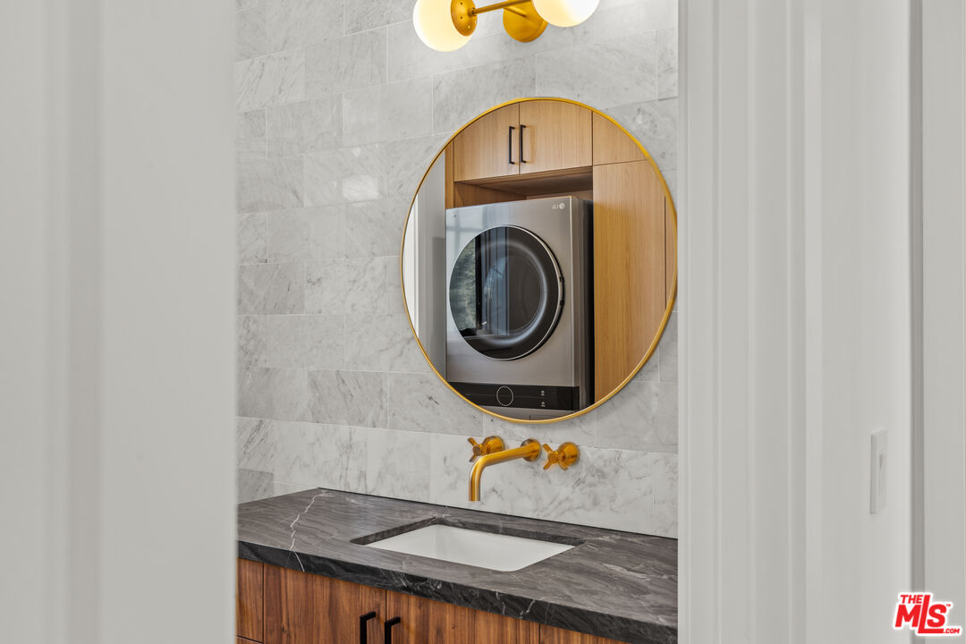 5538 Tova Road Sherman Oaks, CA 91411 - Photo 17 of 19 a bathroom with a sink and a mirror