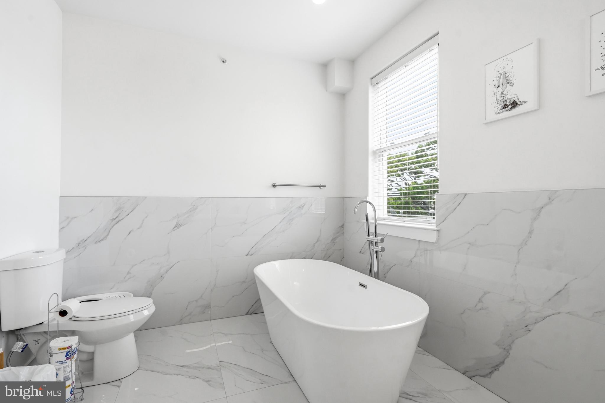 2604 Reed Street Philadelphia, PA 19146 - Photo 14 of 45 a white toilet sitting next to a bathroom sink