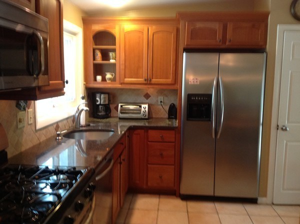 24 Tanglewood Road Needham, MA 02494 - Photo 4 of 8 a kitchen with granite countertop stainless steel appliances and wooden cabinets