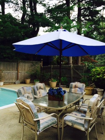 24 Tanglewood Road Needham, MA 02494 - Photo 8 of 8 a view of a patio with table and chairs under an umbrella