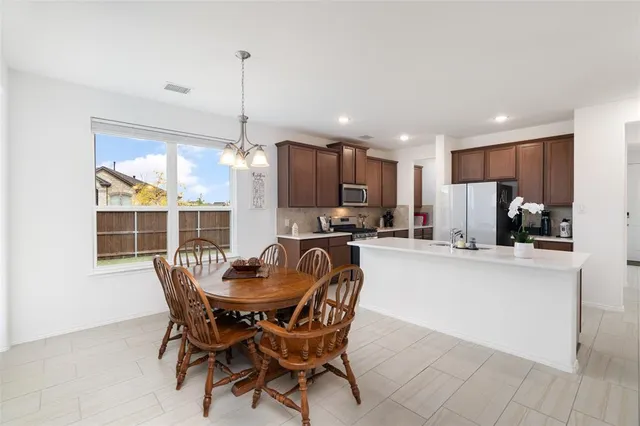 a dining room with furniture and window