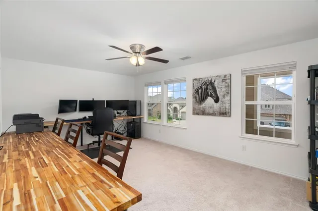 a living room with furniture a window and a flat screen tv