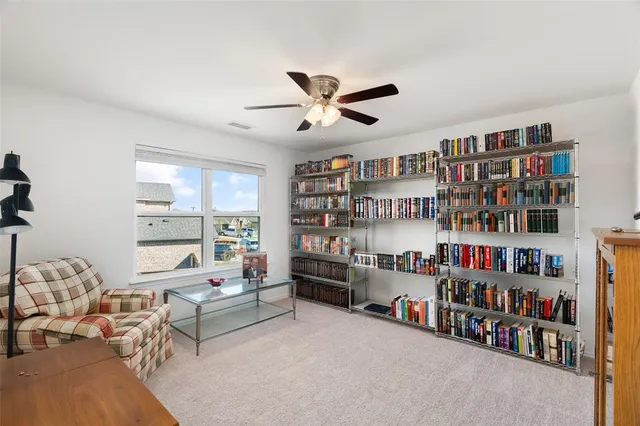 a living room with lots of furniture and a book shelf