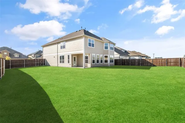 a view of house with backyard