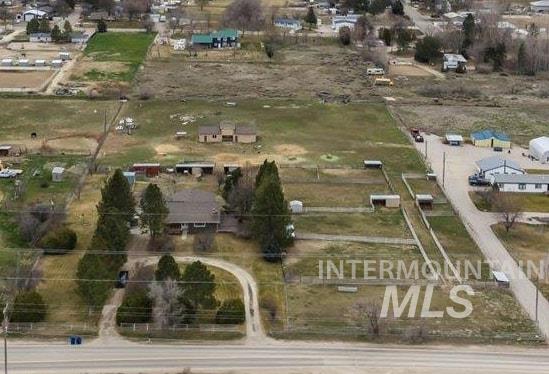 11545 Kuna Road Kuna, ID 83634 - Photo 2 of 50 Aerial view of property and surrounding area featuring a mountainous background and rural landscape
