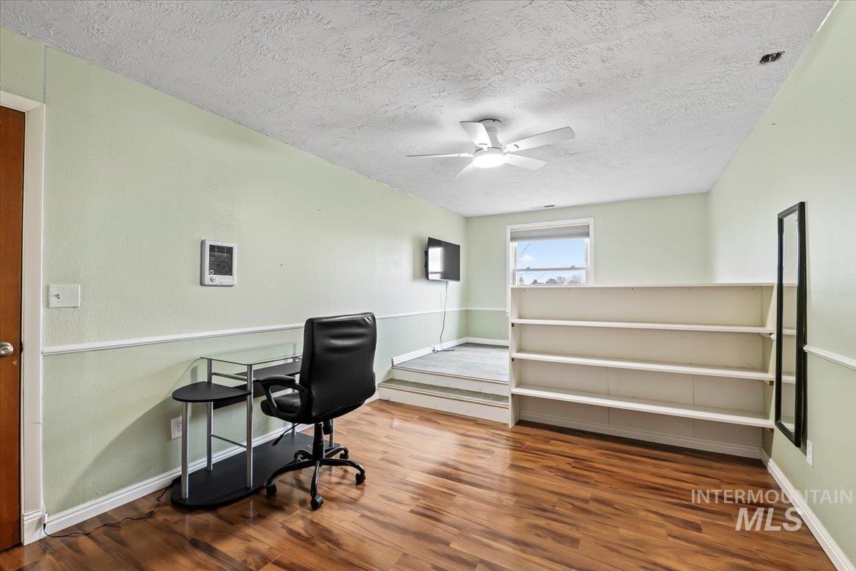 11545 Kuna Road Kuna, ID 83634 - Photo 25 of 50 Home office featuring dark wood-style flooring, a textured ceiling, and a ceiling fan