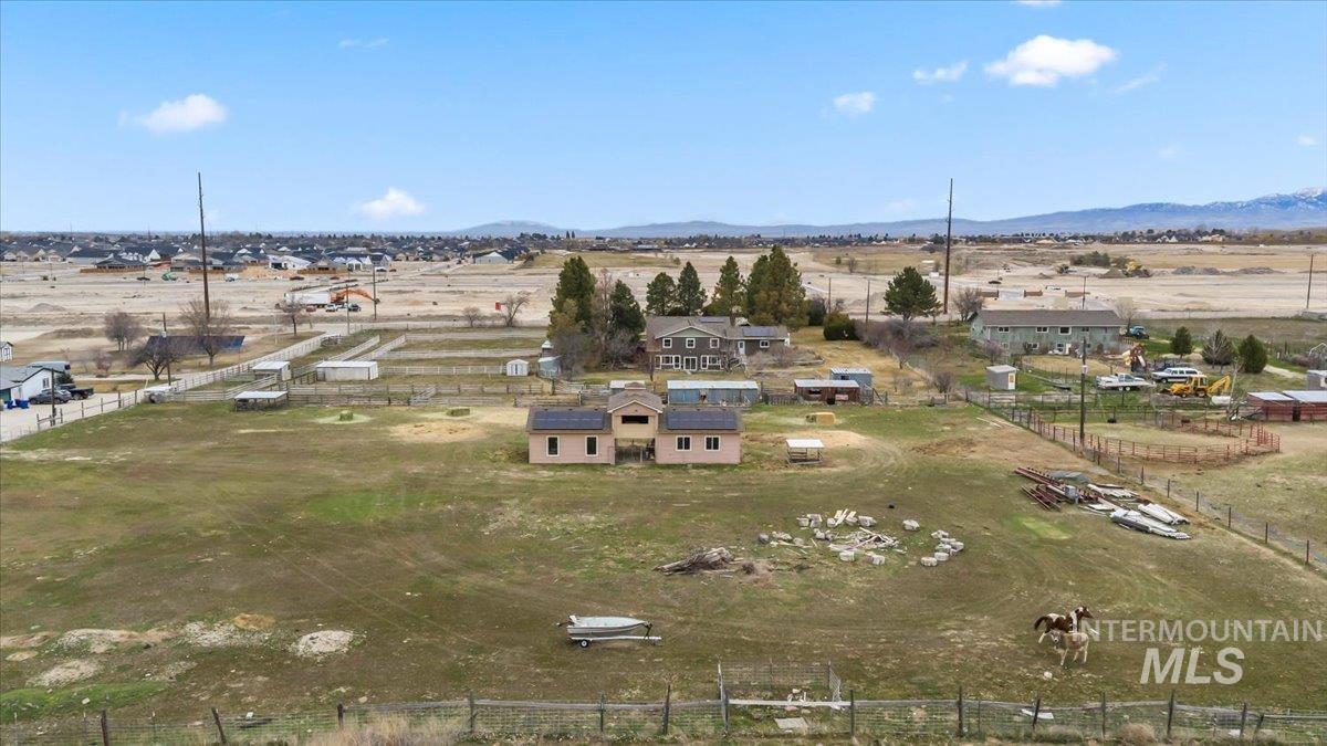 11545 Kuna Road Kuna, ID 83634 - Photo 37 of 50 Aerial view of property and surrounding area featuring rural landscape and a mountain backdrop