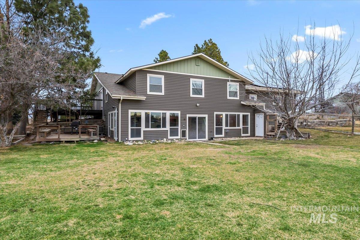 11545 Kuna Road Kuna, ID 83634 - Photo 38 of 50 Rear view of property with a yard and a deck