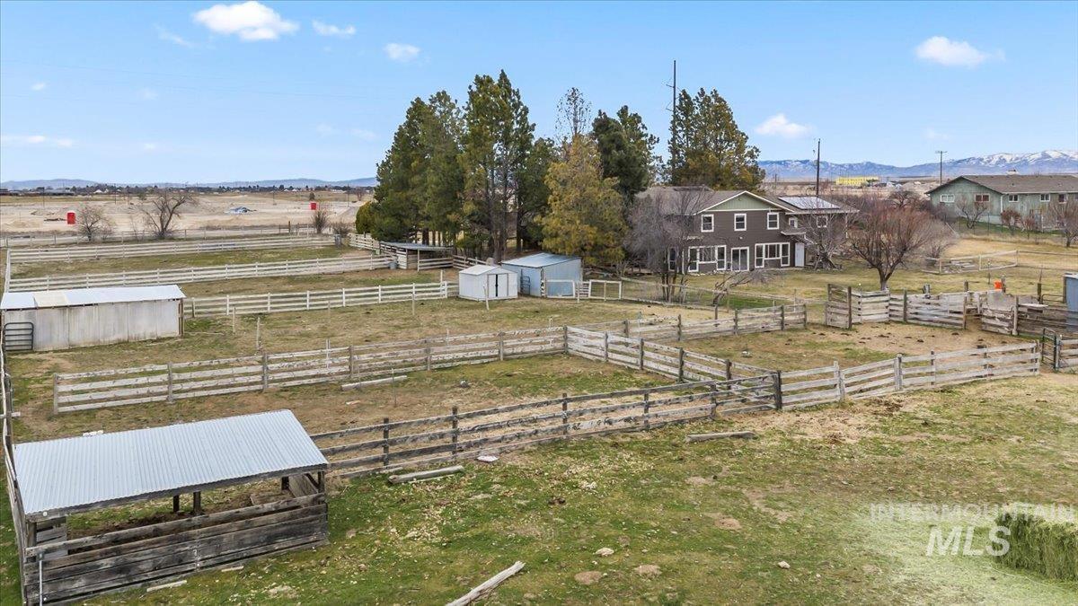 11545 Kuna Road Kuna, ID 83634 - Photo 49 of 50 View of yard featuring a mountain view, a view of rural / East side pastoral area, and a storage shed and wood shelter