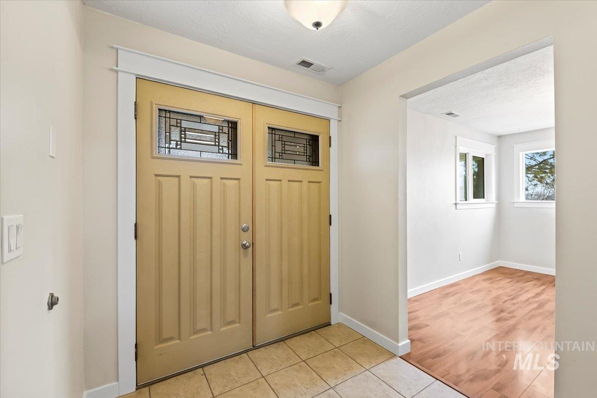 11545 Kuna Road Kuna, ID 83634 - Photo 6 of 50 Entrance foyer featuring a textured ceiling and light tile patterned floors