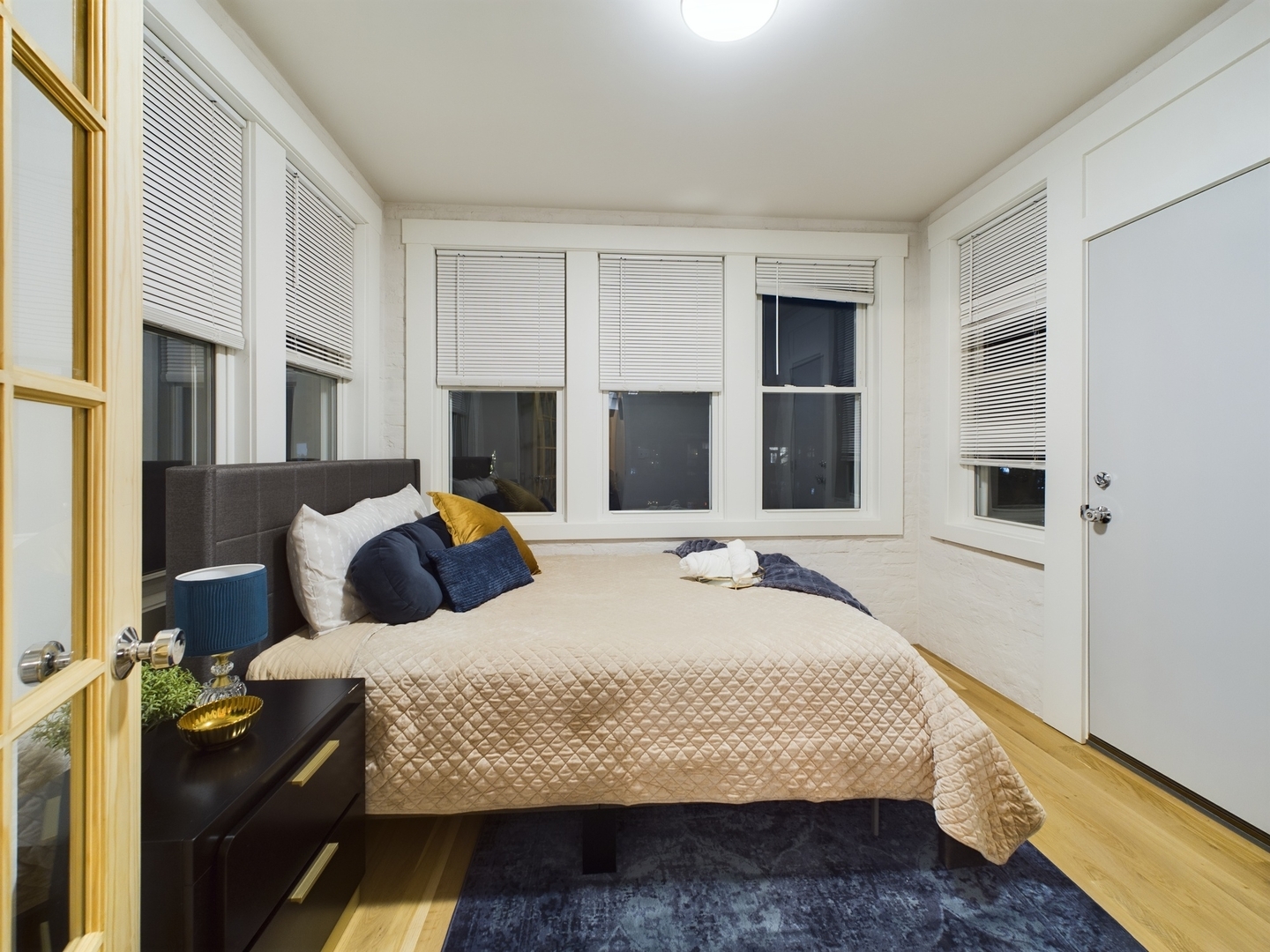 2437 West Walton Street, Unit 2F Chicago, IL 60622 - Photo 16 of 21 a bedroom with a bed and wooden floor