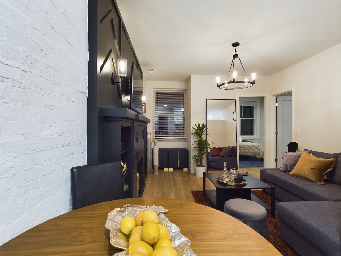 2437 West Walton Street, Unit 2F Chicago, IL 60622 - Photo 7 of 21 a living room with furniture a dining table and a fireplace