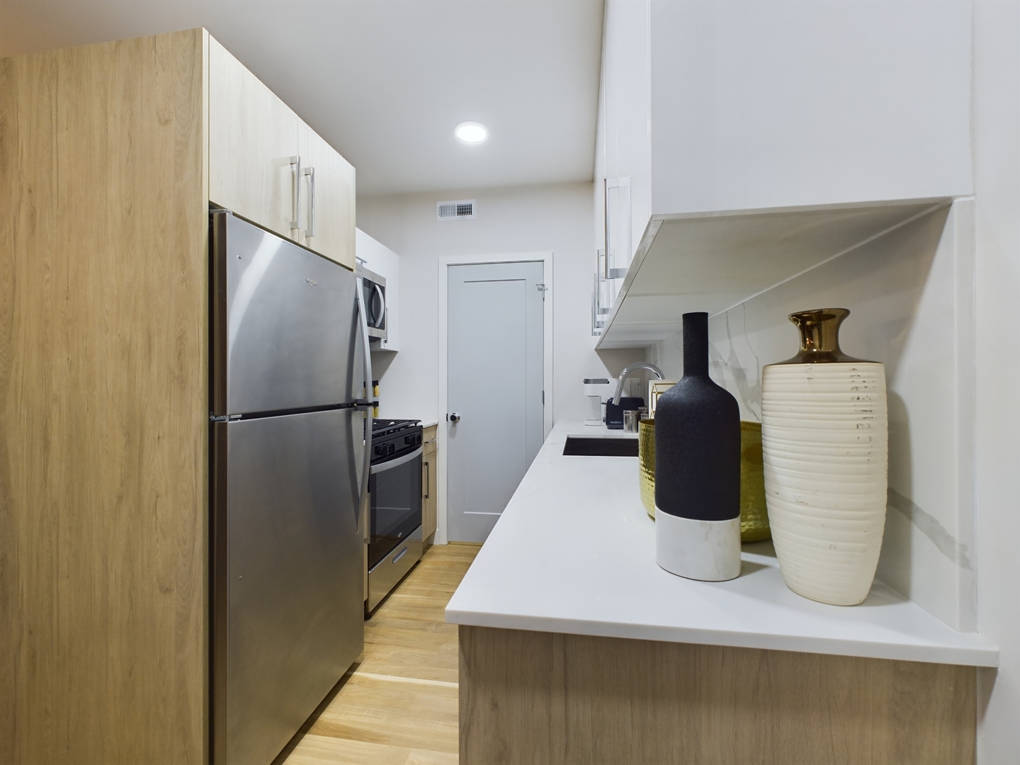 2437 West Walton Street, Unit 2F Chicago, IL 60622 - Photo 8 of 21 a kitchen with a refrigerator and table
