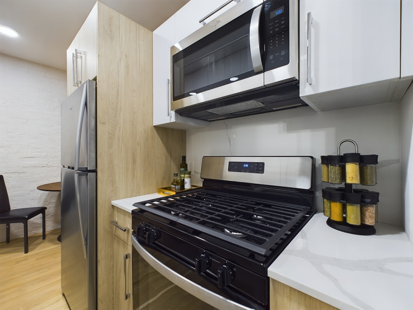 2437 West Walton Street, Unit 2F Chicago, IL 60622 - Photo 10 of 21 a kitchen with stainless steel appliances granite countertop a stove and a microwave