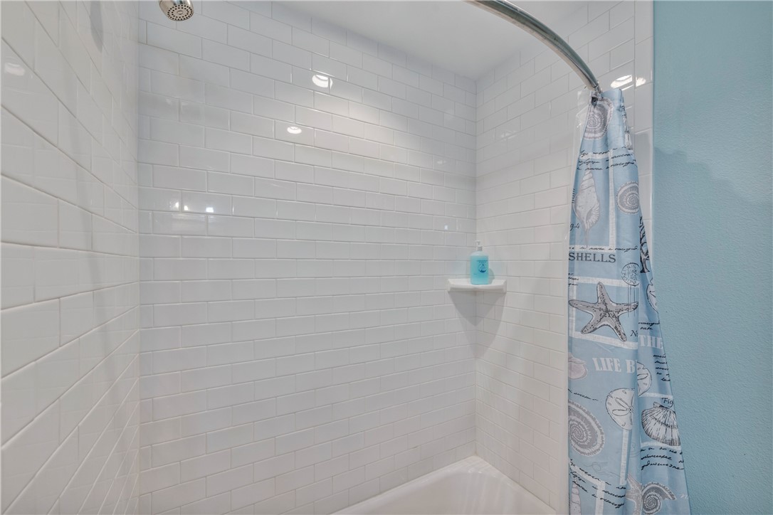 230 Cut-Off Road, Unit 205 Port Aransas, TX 78373 - Photo 18 of 37 a bathroom with a shower