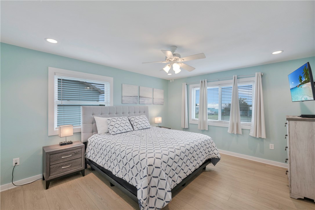 230 Cut-Off Road, Unit 205 Port Aransas, TX 78373 - Photo 21 of 37 a bedroom with a large bed and a window