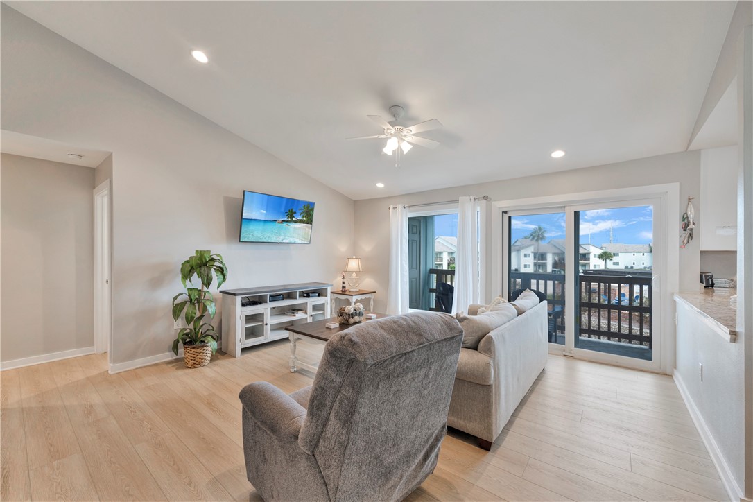 230 Cut-Off Road, Unit 205 Port Aransas, TX 78373 - Photo 4 of 37 a living room with furniture a couch and a potted plant