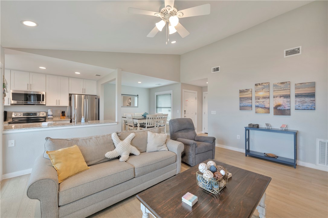 230 Cut-Off Road, Unit 205 Port Aransas, TX 78373 - Photo 7 of 37 a living room with furniture kitchen view and a dining table