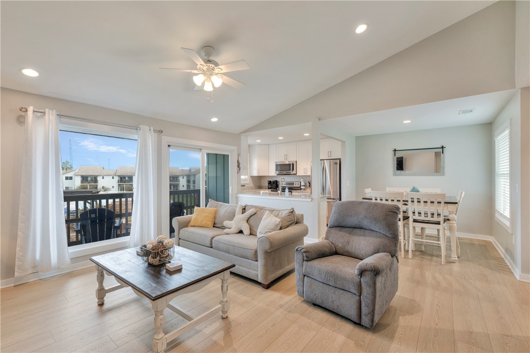 230 Cut-Off Road, Unit 205 Port Aransas, TX 78373 - Photo 8 of 37 a living room with furniture and a large window