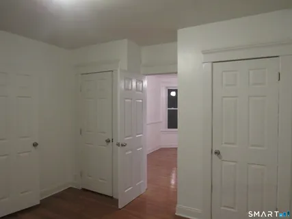 a view of a hallway with wooden floor