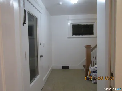 a view of room with stairs and mirrors