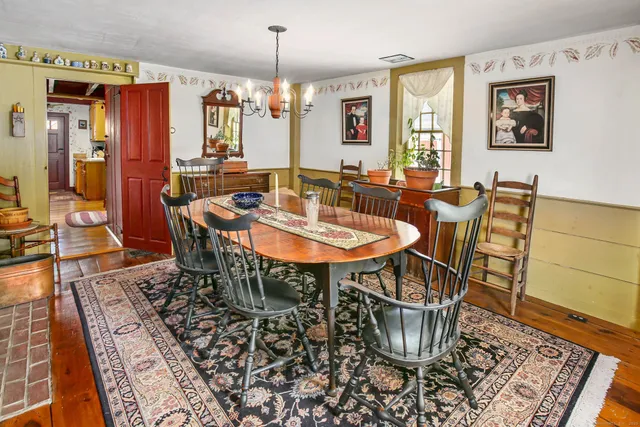 a dining room with furniture a chandelier and wooden floor