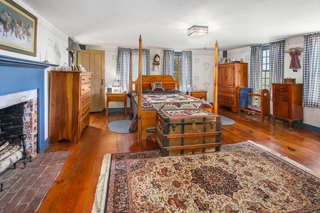 a bedroom with a bed and a fireplace