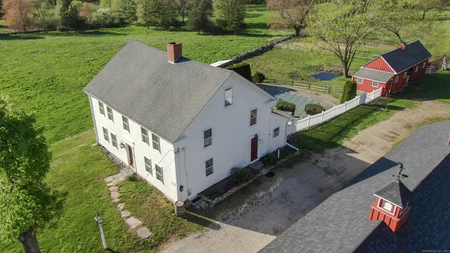 an aerial view of a house with a garden and swimming pool