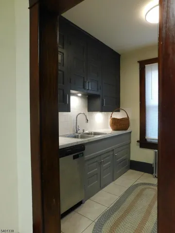 a bathroom with a granite countertop sink a mirror and shower