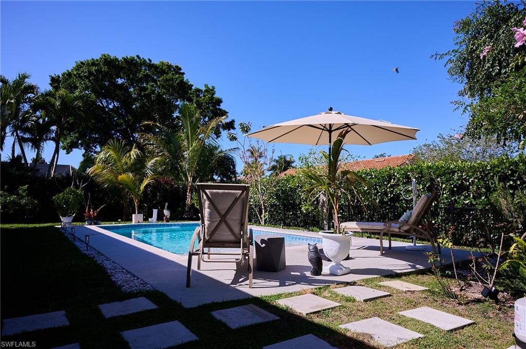 186 Muirfield Circle Naples, FL 34113 - Photo 25 of 36 a view of a chairs and table in the patio