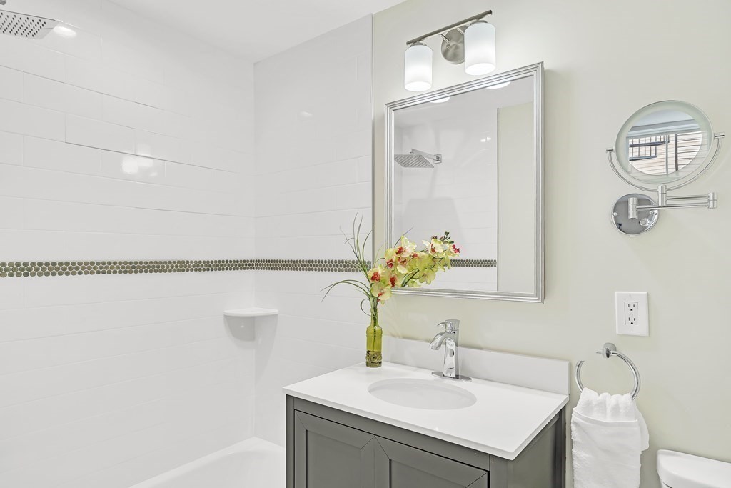 25 Quincy Street, Unit R Somerville, MA 02143 - Photo 13 of 17 a bathroom with a sink and a mirror
