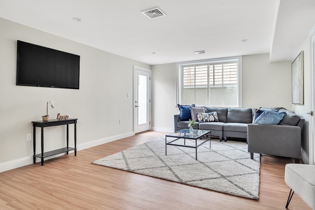 25 Quincy Street, Unit R Somerville, MA 02143 - Photo 14 of 17 a living room with furniture and a flat screen tv