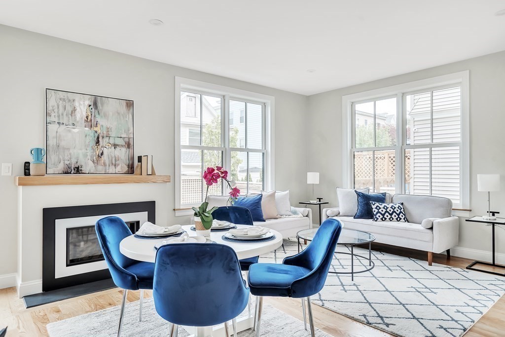 25 Quincy Street, Unit R Somerville, MA 02143 - Photo 4 of 17 a dining room with furniture a large window and wooden floor