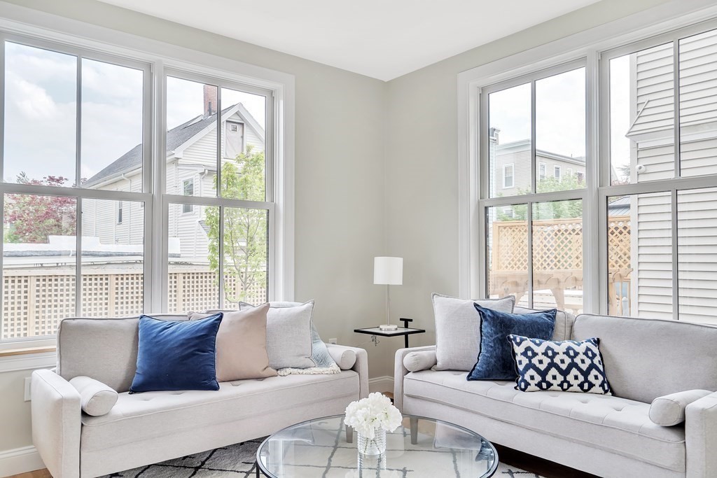 25 Quincy Street, Unit R Somerville, MA 02143 - Photo 5 of 17 a living room with furniture and a large window with outer view