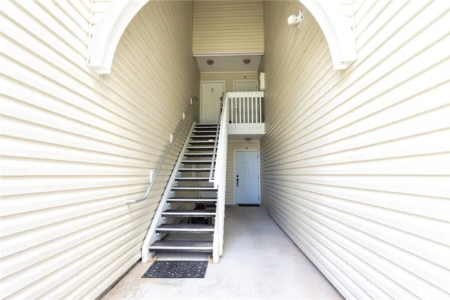a view of a balcony with wooden floor and windows