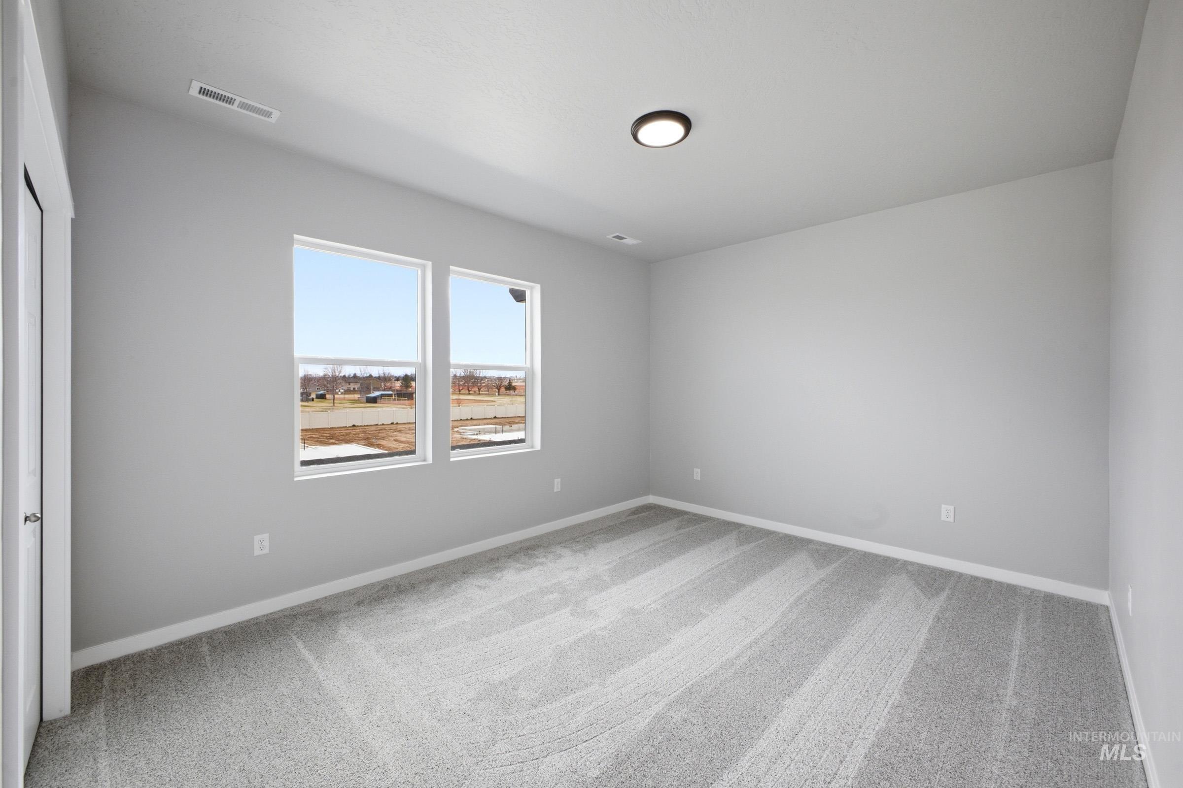 13672 Redway Court Caldwell, ID 83607 - Photo 25 of 34 Empty room with light carpet and baseboards