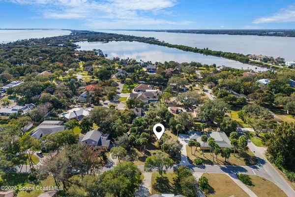 an aerial view of residential house with yard and outdoor seating