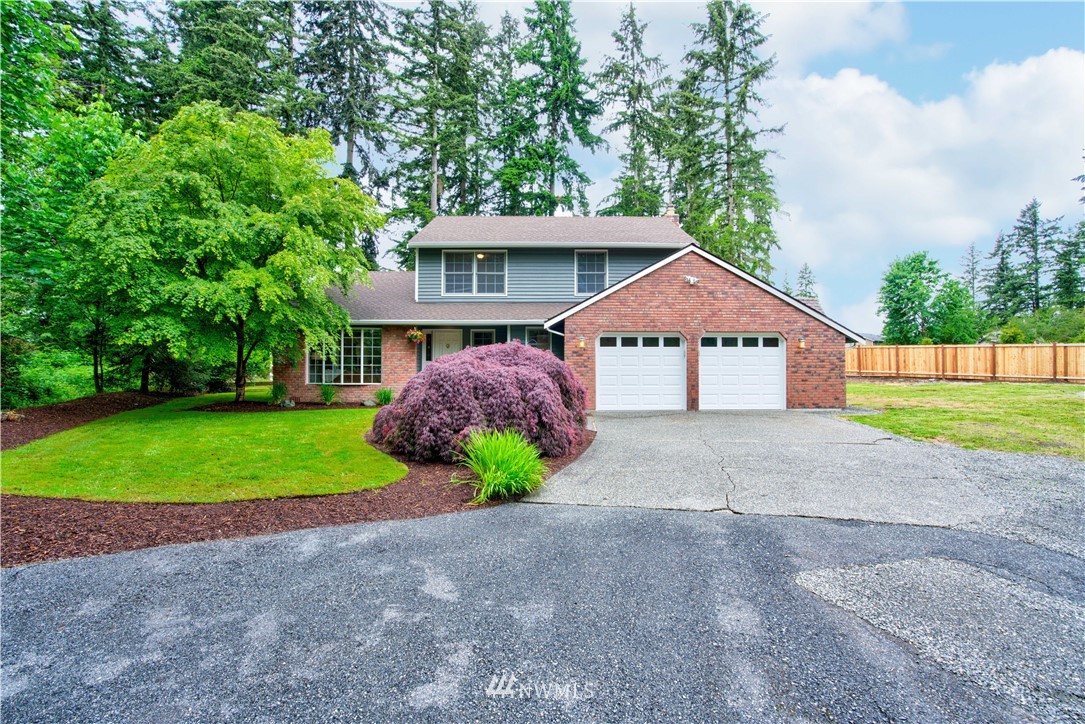 18322 Bellflower Road Bothell, WA 98012 - Photo 1 of 34 a front view of a house with a yard and garage