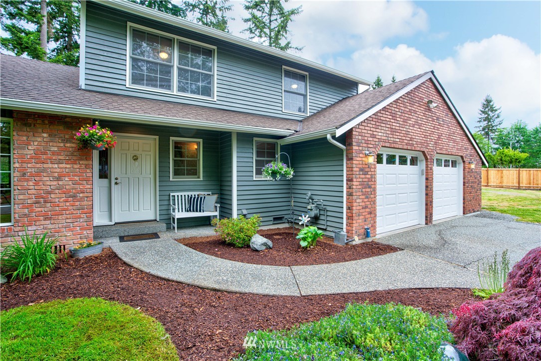 18322 Bellflower Road Bothell, WA 98012 - Photo 2 of 34 a front view of a house with garden