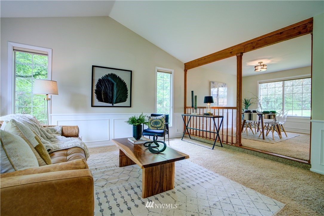 18322 Bellflower Road Bothell, WA 98012 - Photo 12 of 34 a living room with furniture and a flat screen tv