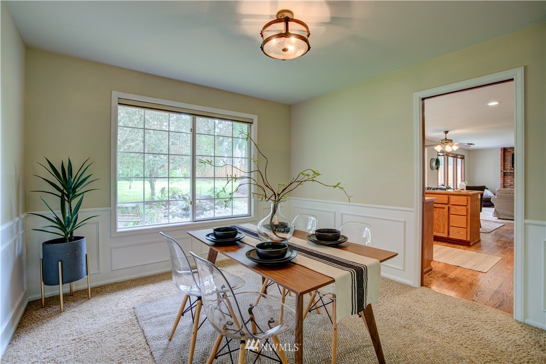 18322 Bellflower Road Bothell, WA 98012 - Photo 14 of 34 a view of a dining room with furniture and a table