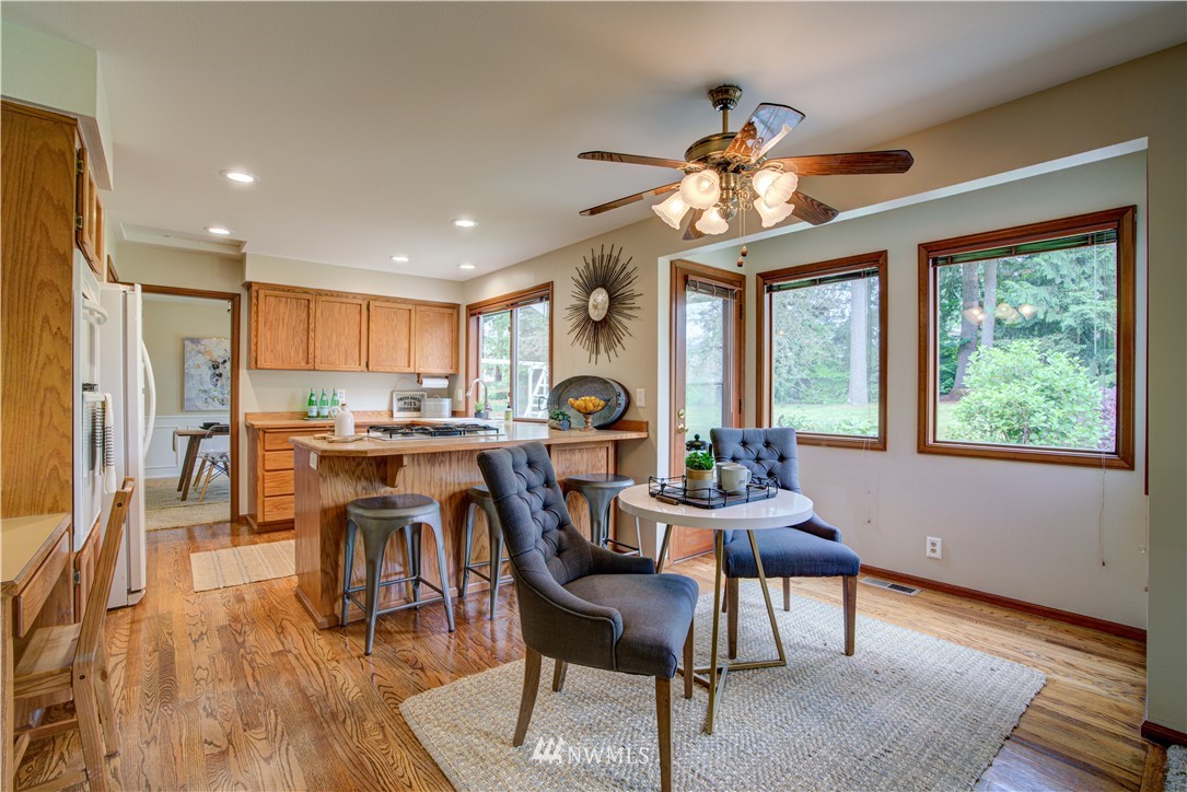 18322 Bellflower Road Bothell, WA 98012 - Photo 18 of 34 a view of a dining room with furniture window and wooden floor