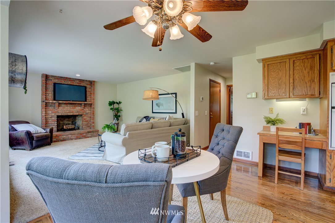 18322 Bellflower Road Bothell, WA 98012 - Photo 19 of 34 a living room with furniture a fireplace and a flat screen tv