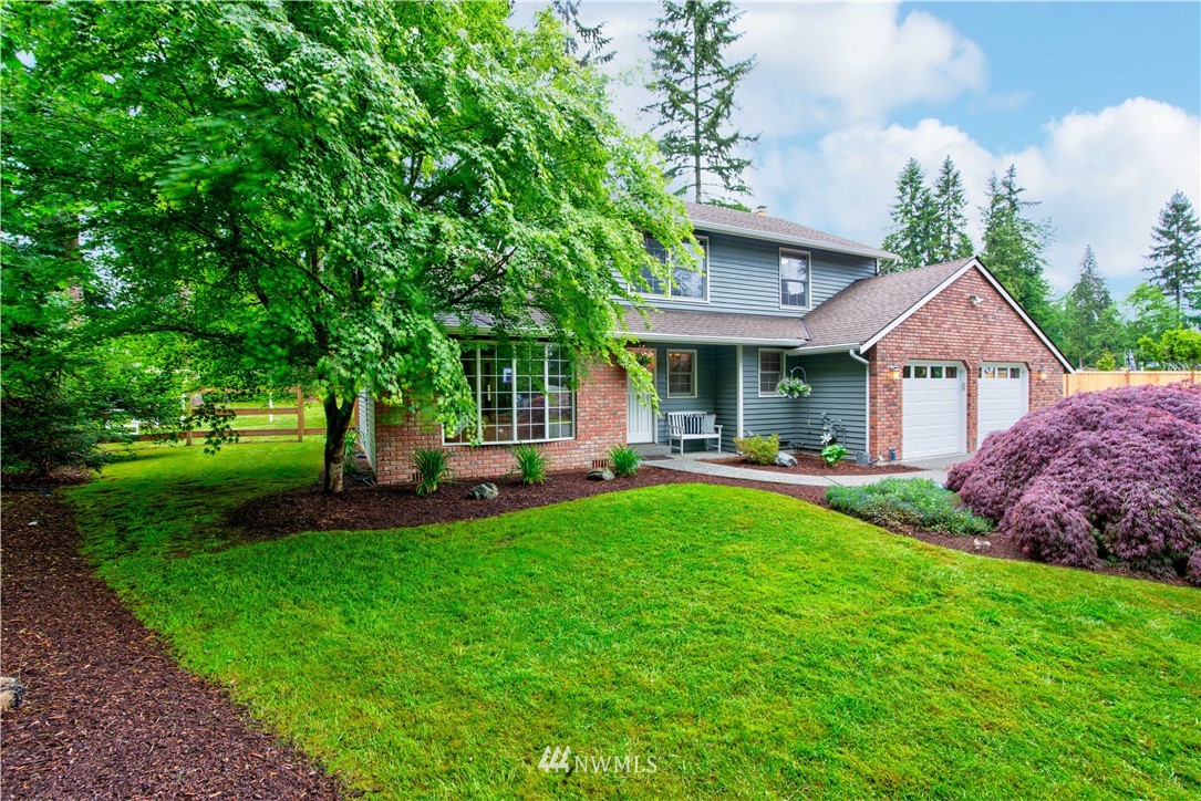 18322 Bellflower Road Bothell, WA 98012 - Photo 3 of 34 a front view of a house with swimming pool having outdoor seating