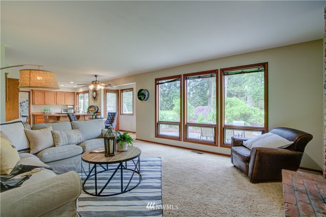 18322 Bellflower Road Bothell, WA 98012 - Photo 22 of 34 a living room with furniture and a floor to ceiling window