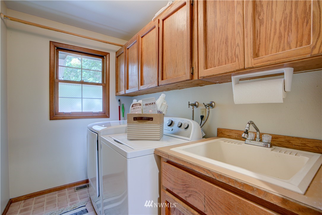 18322 Bellflower Road Bothell, WA 98012 - Photo 23 of 34 a kitchen that has a sink and a stove