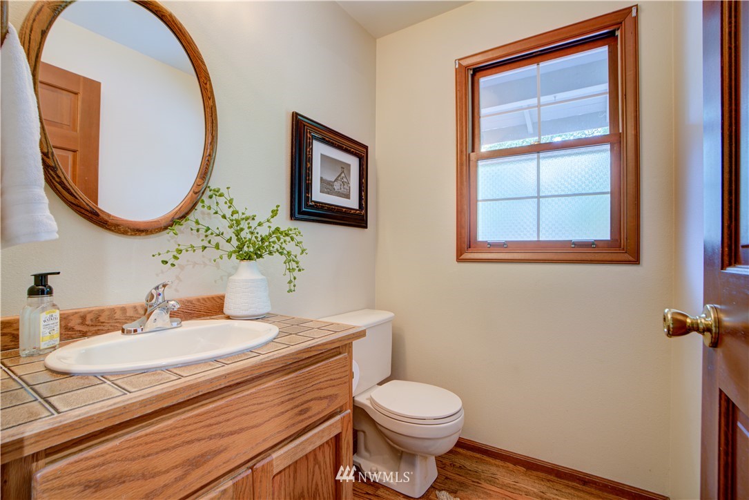18322 Bellflower Road Bothell, WA 98012 - Photo 24 of 34 a bathroom with a sink a mirror and a toilet