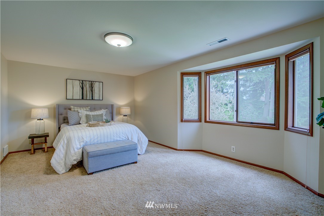 18322 Bellflower Road Bothell, WA 98012 - Photo 26 of 34 a bedroom with a bed and a large window