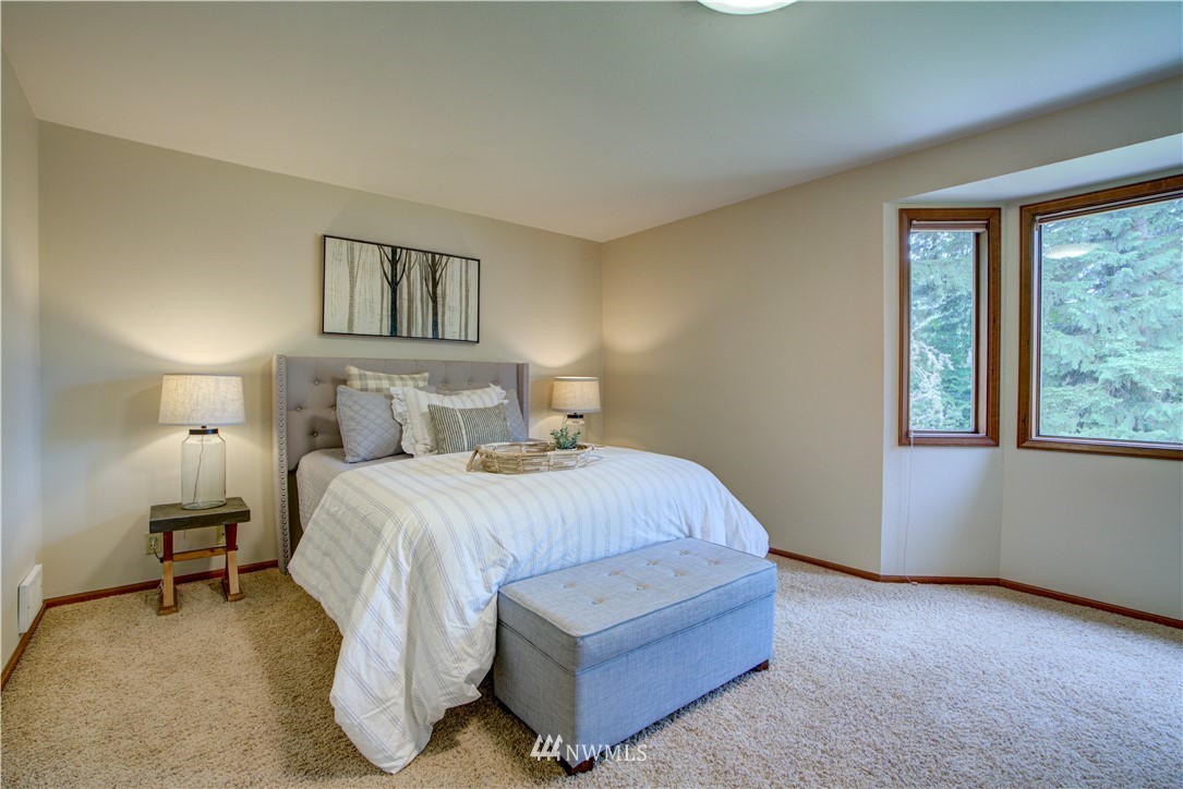18322 Bellflower Road Bothell, WA 98012 - Photo 27 of 34 a bedroom with a bed lamp and a large window
